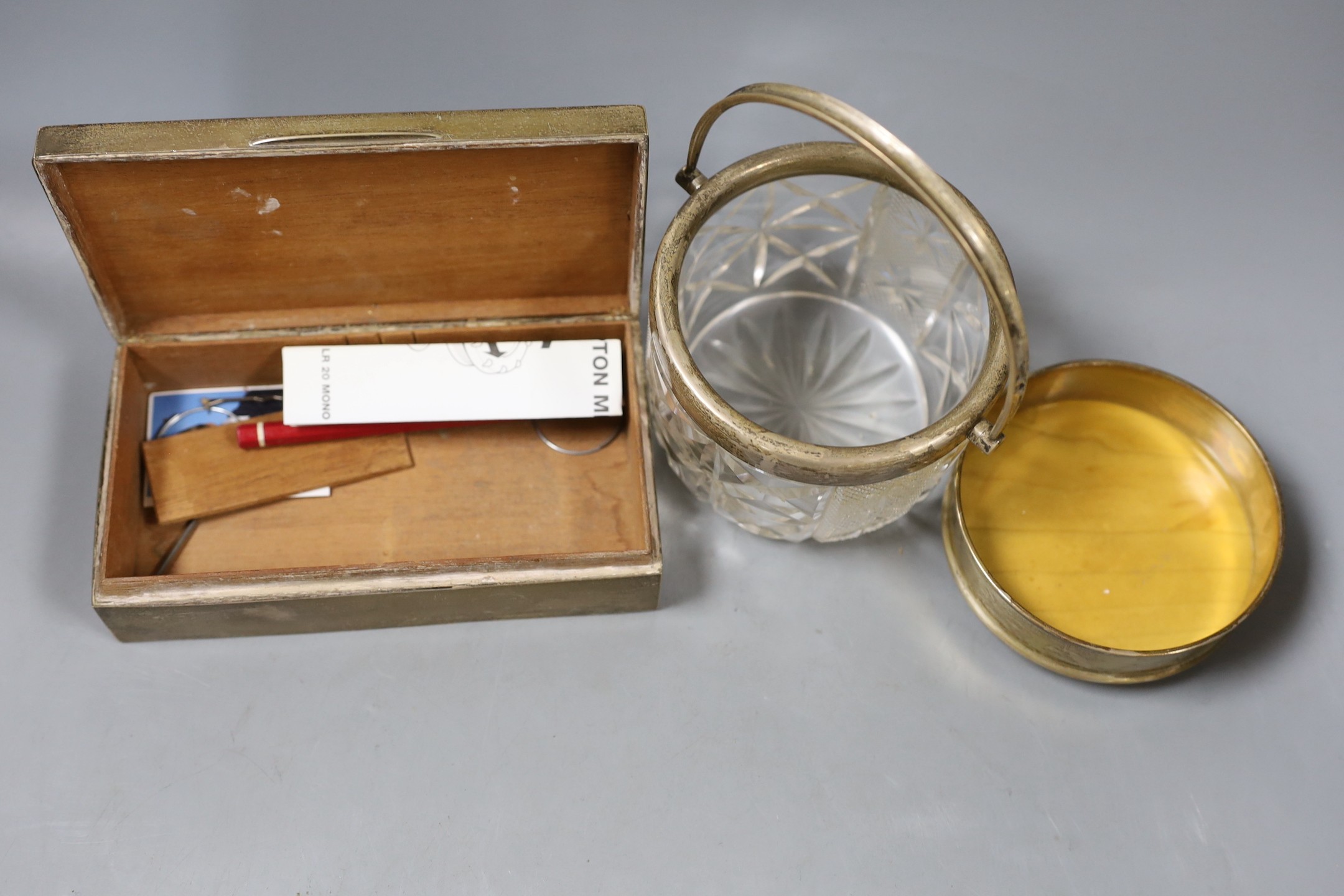 A silver cigarette box, 16.7cm, a silver cream jug, a silver mounted glass jar and a modern silver mounted coaster.